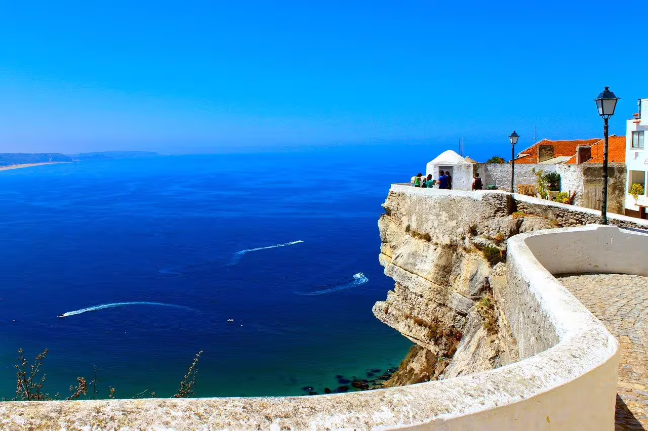Stunning view of the Atlantic Ocean from a scenic cliffside promenade in Nazaré, Portugal, perfect for coastal exploration tours.