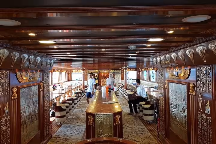 Elegant Nefertari Cruise Marsa Alam interior lounge with pharaonic decor, dining area, and onboard service