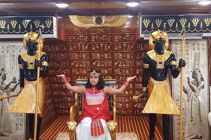 Pharaoh-themed salon on Nefertari Cruise Marsa Alam, guest on throne during lunch or dinner boat tour