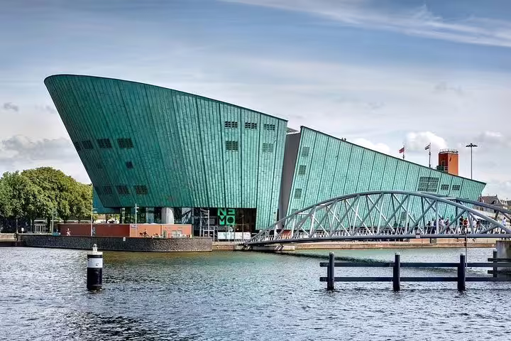 NEMO Science Museum and footbridge on Amsterdam waterfront, featured on a private half-day city sightseeing tour