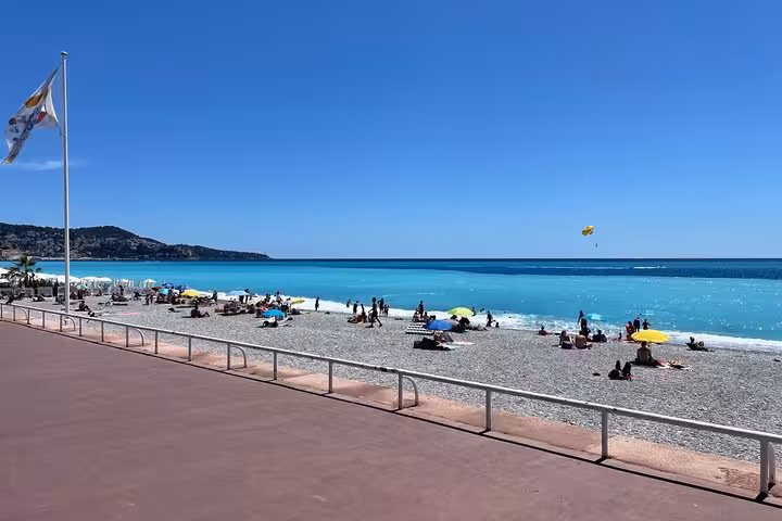 Nice Promenade des Anglais beach and turquoise Mediterranean, coastal view on a private Nice Eze Monaco day tour