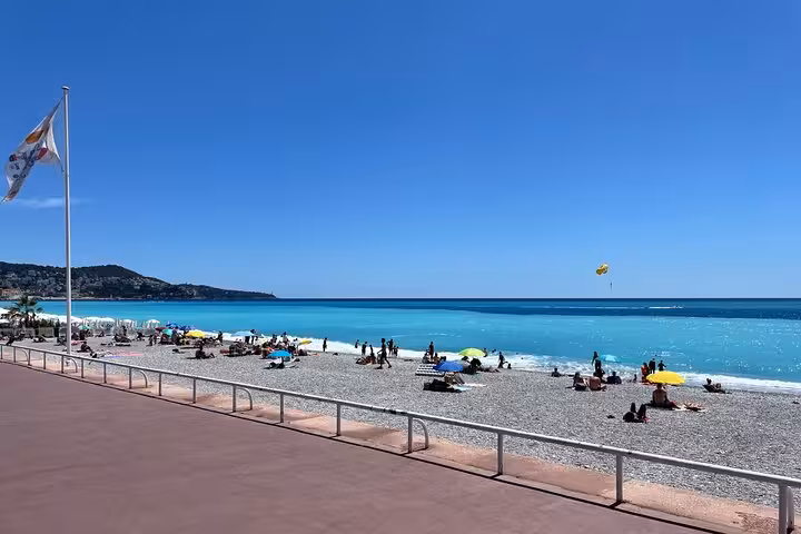 Nice Promenade des Anglais beach and turquoise Mediterranean sea, relaxing stop on private day trip to Eze and Monaco