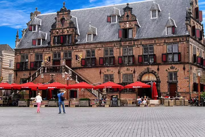 Historic Waag building on Nijmegen Grote Markt with cafés, a key stop on the self-paced e-scavenger hunt tour