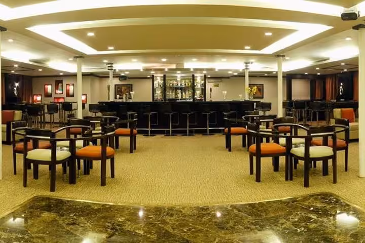 Elegant Nile cruise bar lounge on 6-day Aswan to Luxor itinerary with domestic flight, comfy seating and bar