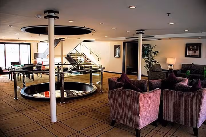 Modern lounge seating area aboard Nile cruise ship on 6-day Aswan to Luxor tour with domestic flight package
