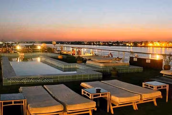 Rooftop pool and sun loungers on Nile cruise ship at sunset, 6-day Aswan to Luxor tour with flight