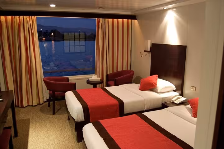 Twin-bed Nile cruise cabin at night, Aswan to Luxor 6 day itinerary with domestic flight and river views