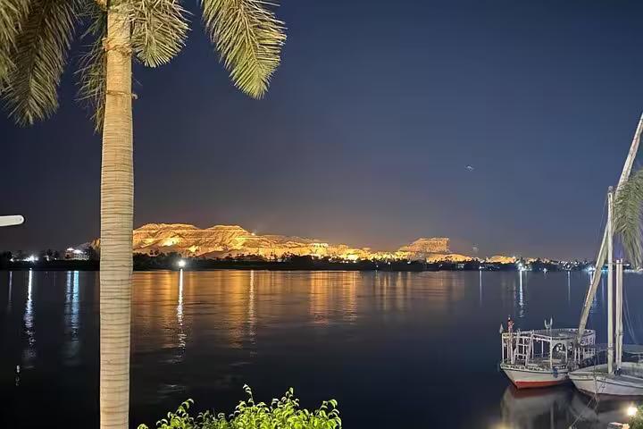 Night view of the Nile with palm tree and Dahabiya, scenic Luxor to Aswan VIP cruise 4 nights 5 days