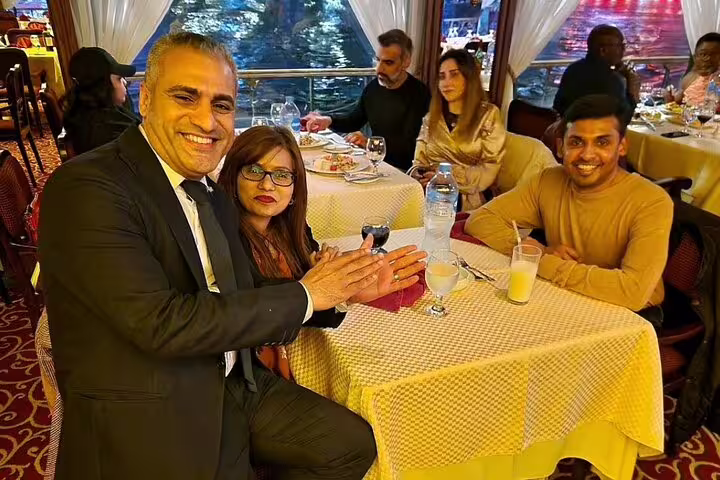 Guests dining on Nile Maxim Cruise in Cairo with river views, enjoying luxury Nile dinner cruise and live show