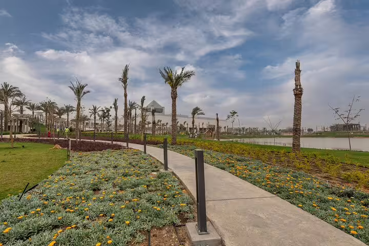 Palm-lined walkway and gardens near NMEC, ideal start for a half day tour to the National Museum of Egyptian Civilization