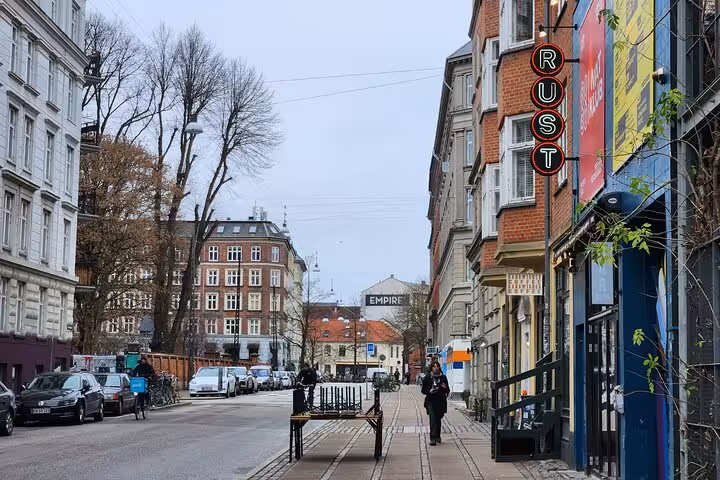 Scenic Copenhagen street view with vibrant architecture and pedestrians, perfect for exploring the Danish lifestyle.