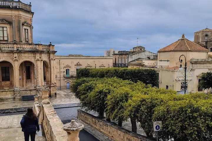 Scenic vista of Noto's baroque buildings and lush greenery, inviting exploration on a leisurely city tour.