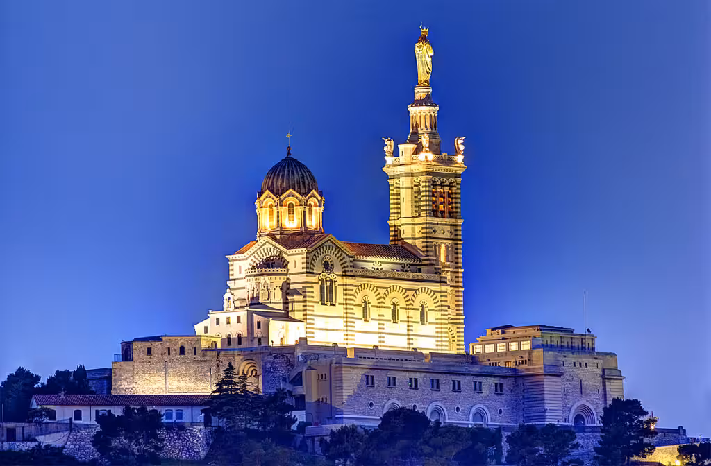 Notre-Dame de la Garde basilica lit at dusk in Marseille, highlight of private day tour to Cassis and Le Castellet