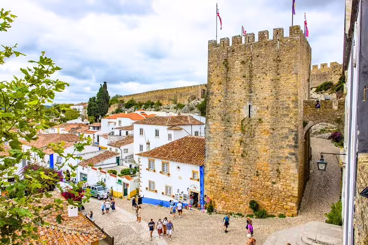Medieval Óbidos town with its historic castle and cobblestone streets, featured in a small group day tour from Lisbon.