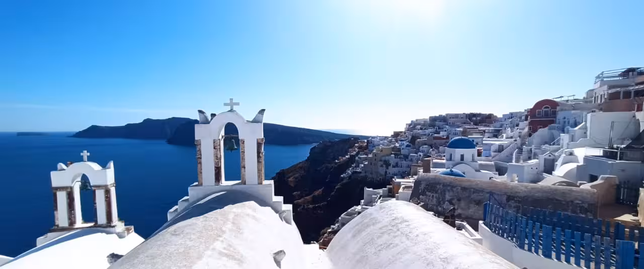 Oia Santorini caldera view with blue dome and white church bells, ideal stop on 5-hour cruise shore tour