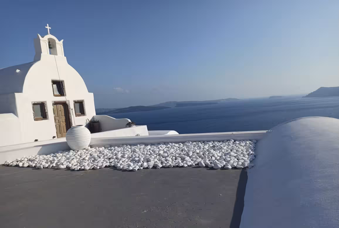 Oia Santorini caldera viewpoint on 4-hour cruise shore excursion, white chapel rooftop and Aegean sea