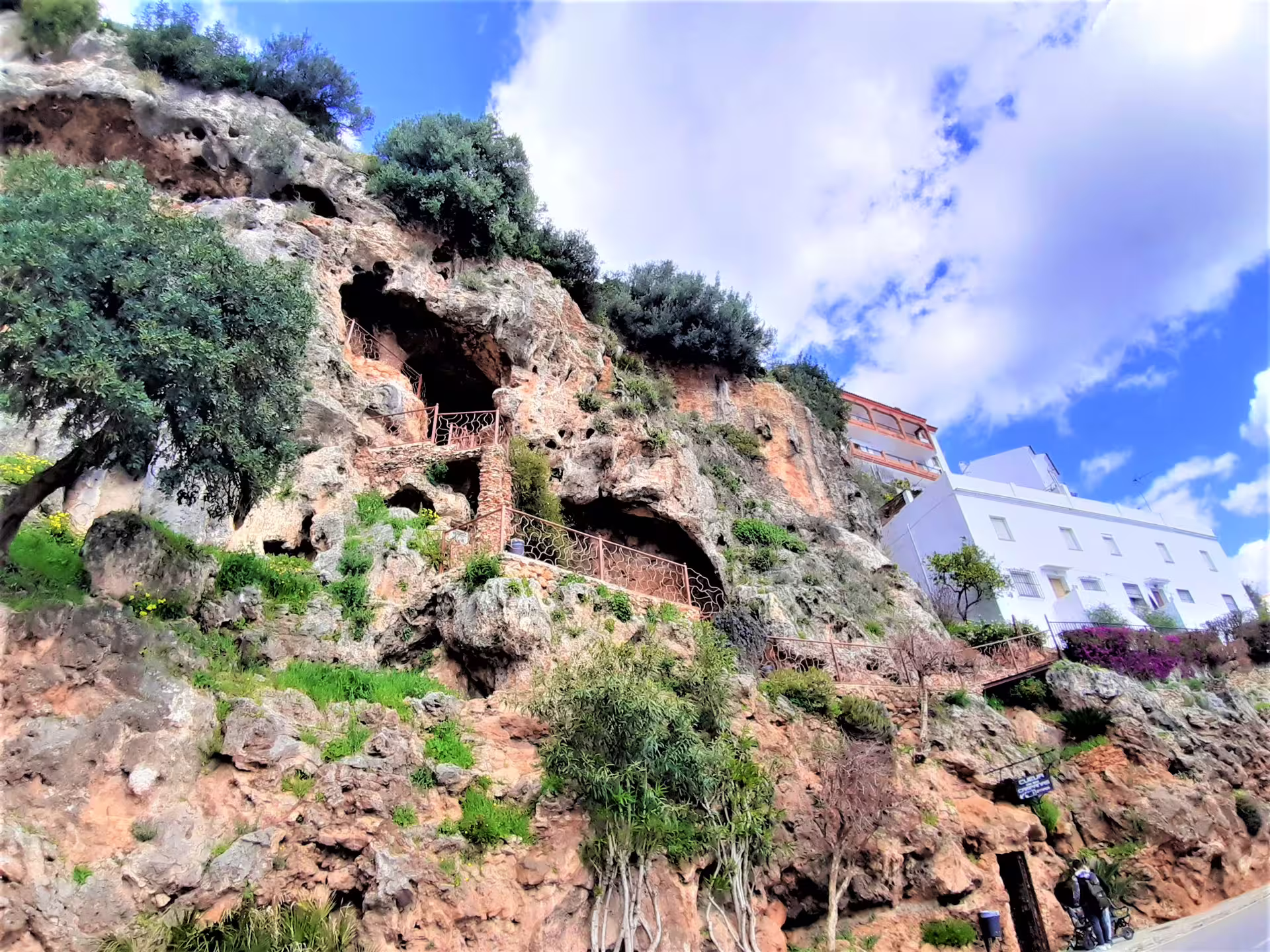 Ojen cave houses and cliffside viewpoint stop on a private walking tour, with white village buildings above