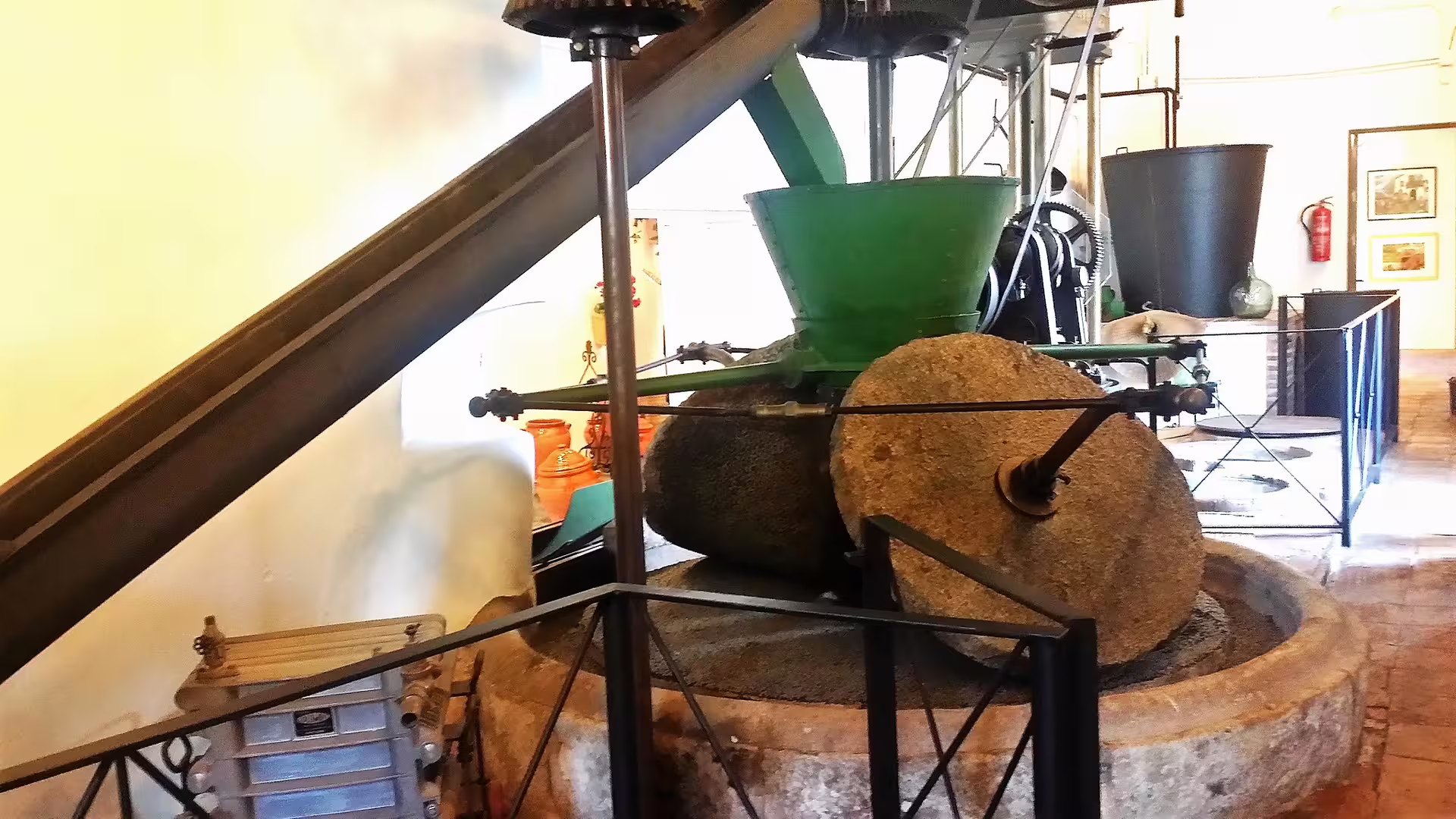 Traditional olive mill with stone grinding wheel in Ojen, visited on a private walking tour of local heritage sites