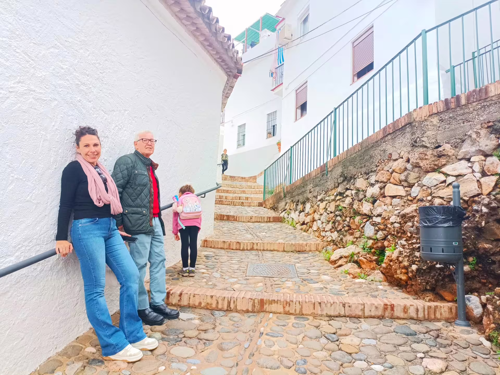 Guests on an Ojen private walking tour on a cobblestone lane with whitewashed houses and steps
