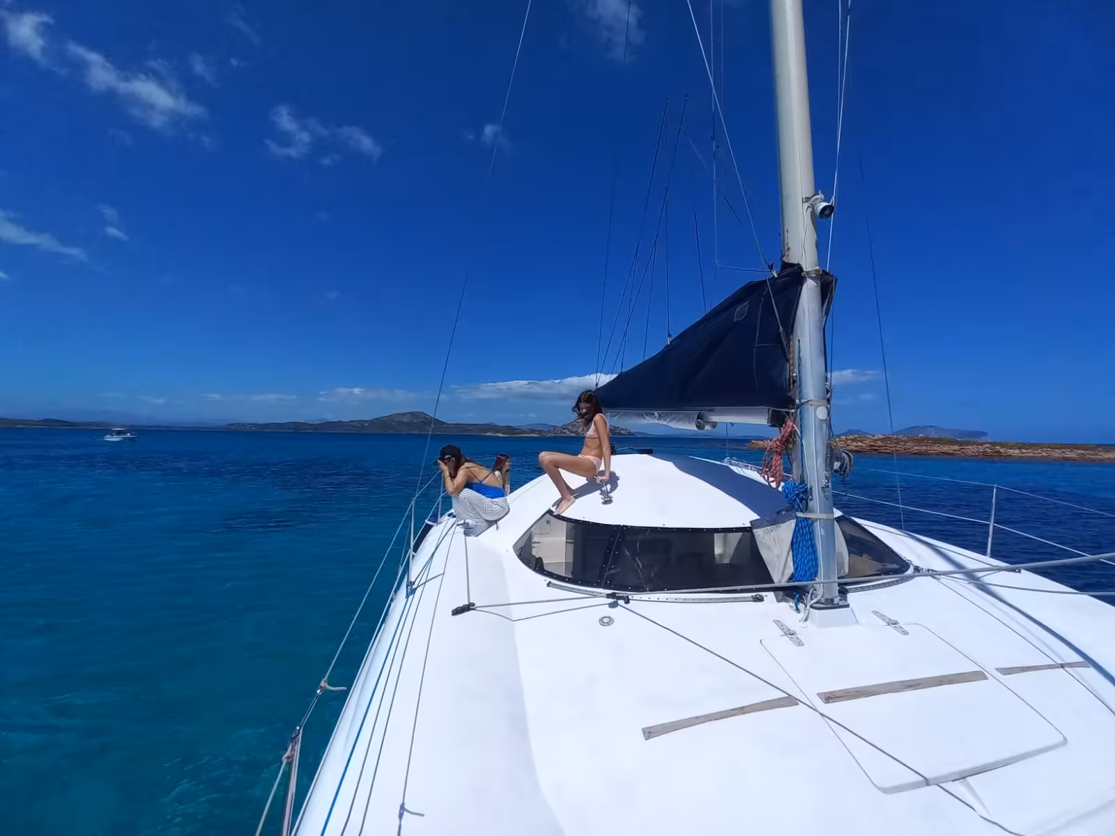 Experience a catamaran adventure from Olbia to Cala Moresca, capturing the scenic beauty of Sardinia's coastline.