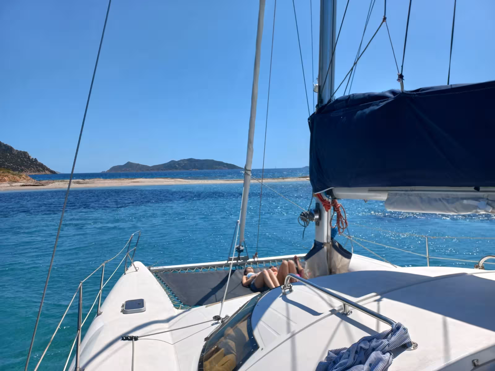 Relax on a catamaran tour with stunning views of Tavolara from Olbia, enjoying the clear turquoise waters.