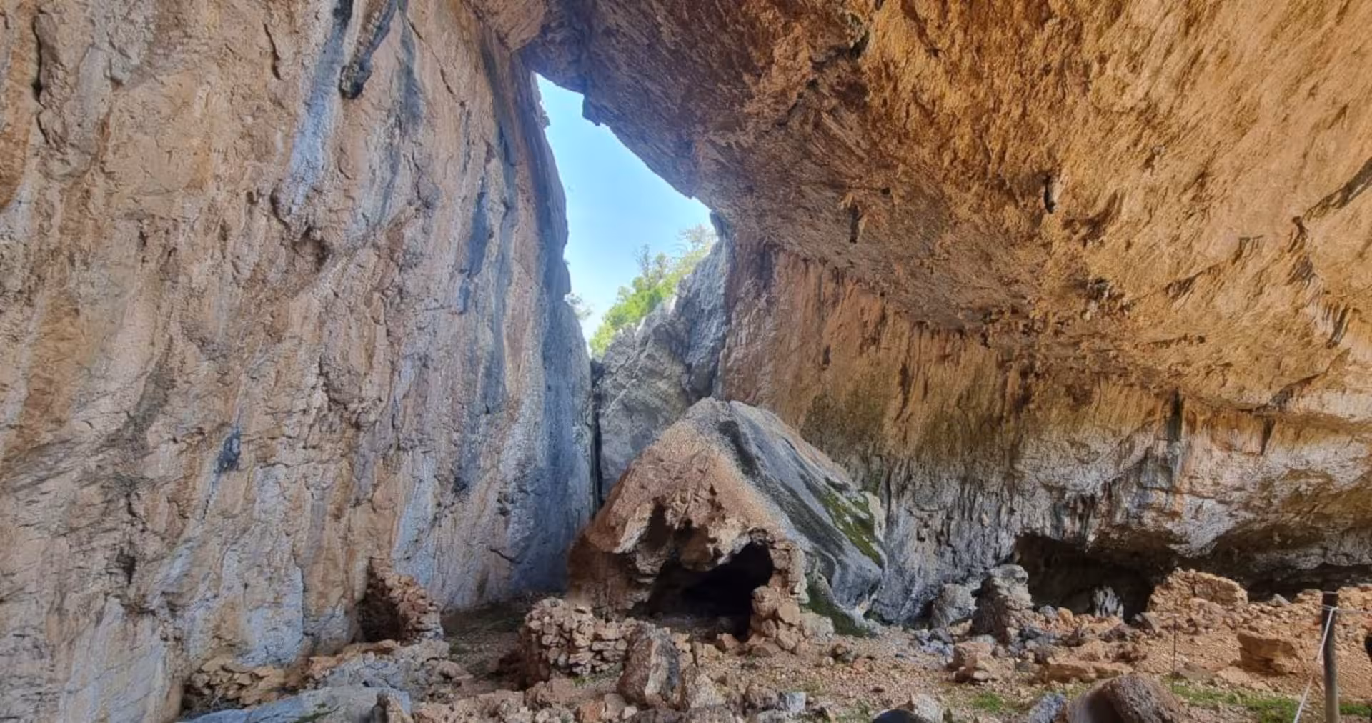Explore the ancient Tiscali cave with stunning rock formations on the Oliena trekking tour to Mount Tiscali.