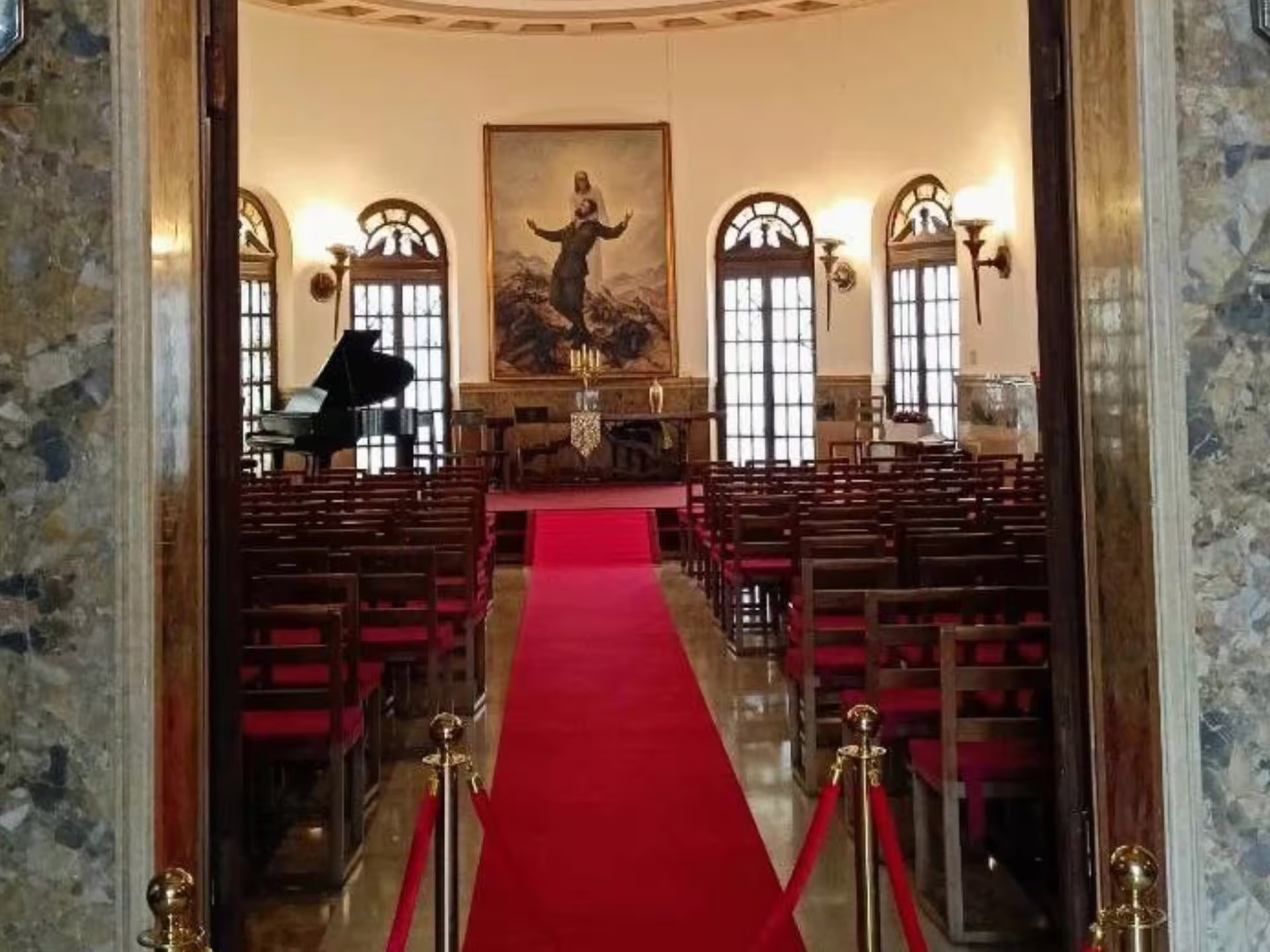 Elegant concert hall in Verona Palace set for opera evening with red carpet and grand piano, perfect for a cultural escape.