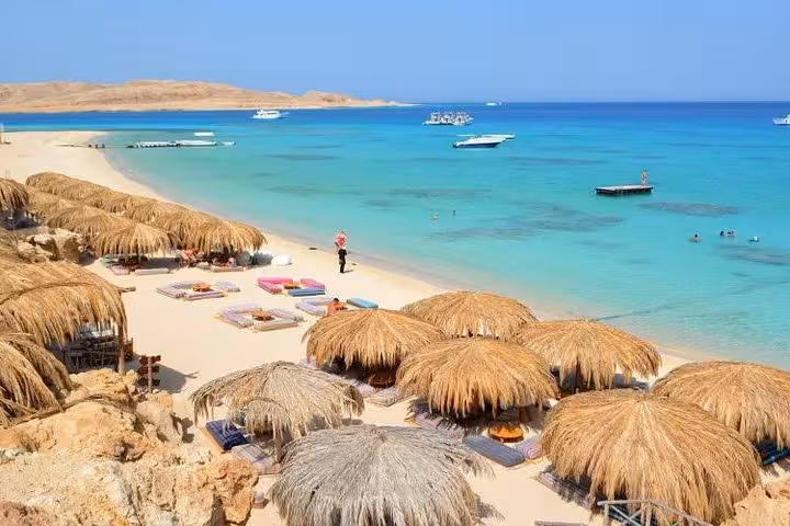 Orange Bay Giftun Island beach with straw umbrellas, sunbeds and turquoise Red Sea lagoons, Hurghada