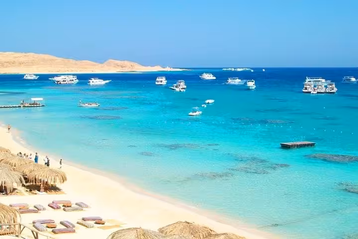 Panoramic Orange Bay shoreline with yachts on clear Red Sea, Giftun Island National Park cruise and snorkeling