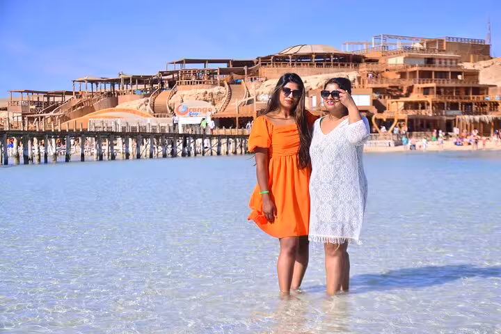 Women in shallow Orange Bay lagoon on Giftun Island, Hurghada snorkeling boat trip with lunch on Red Sea