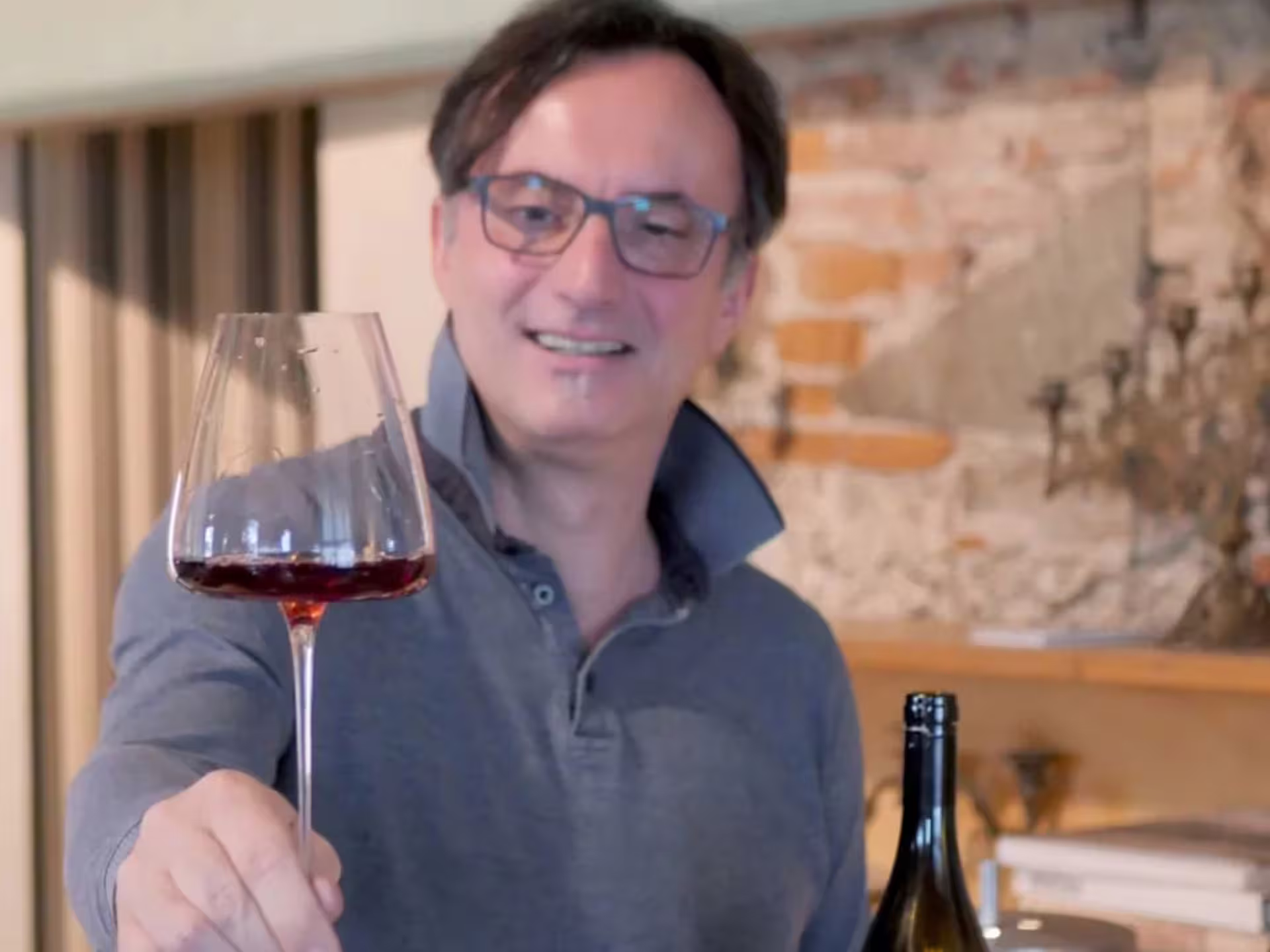 Winemaker pours organic red wine during Turin winery visit with guided tasting and local food pairing