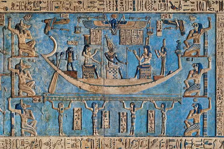 Colorful ancient Egyptian relief of Osiris boat and hieroglyphs inside Abydos Temple on Luxor day trip