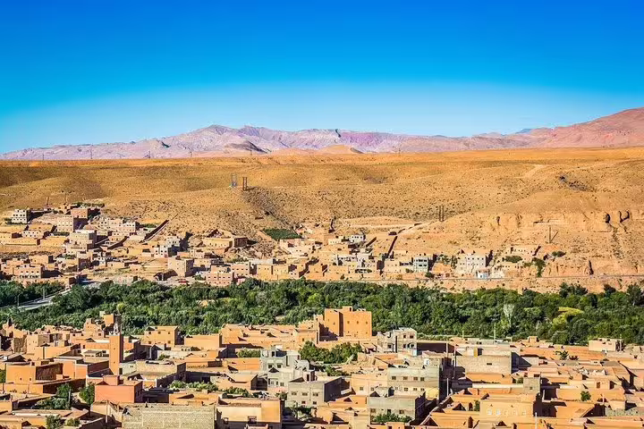 Panoramic view of Ouarzazate oasis and desert hills, a highlight on Morocco 10 days tour from Casablanca