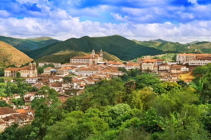 Panoramic view of Ouro Preto's colonial architecture nestled in lush hills on the Gold Route tour from Rio.
