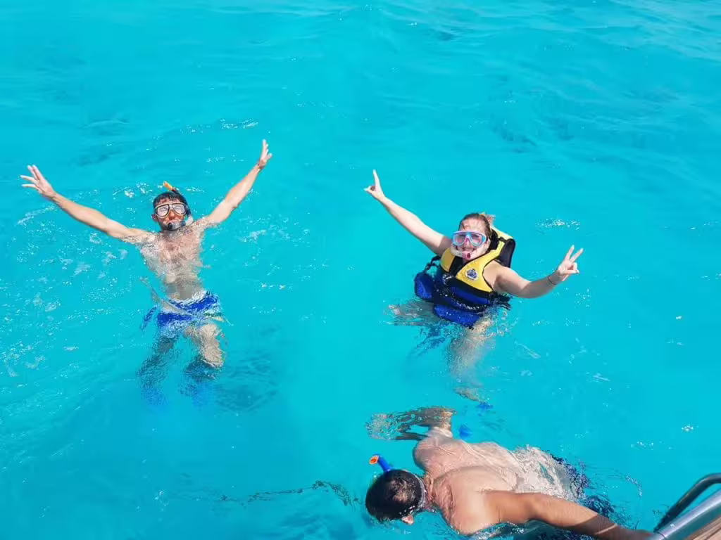 Guests snorkeling and swimming in turquoise water on the Paradise Island day tour, Red Sea boat excursion