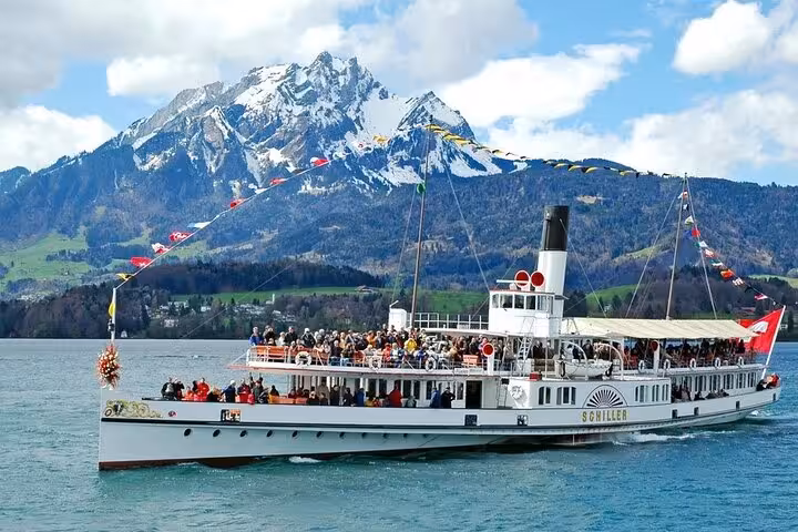 Historic paddle steamer cruising on Lake Lucerne with the Swiss Alps in the background, ideal for a guided tour.