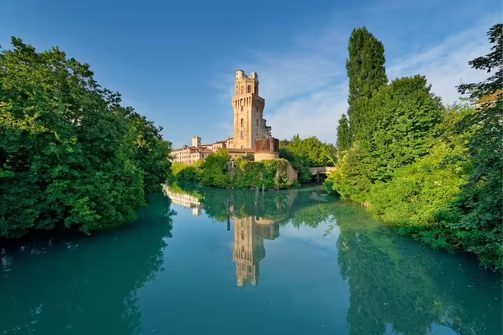 Padua self-guided scavenger hunt tour view of La Specola tower reflected in the Bacchiglione River