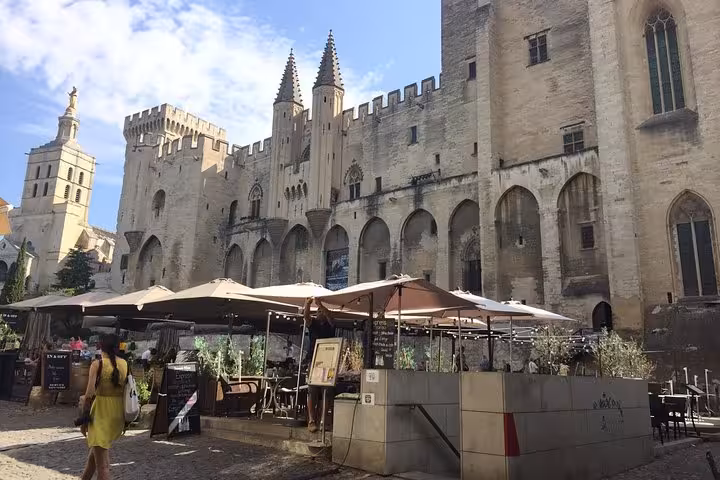 Palais des Papes in Avignon with café terraces, key landmark on the Popes Palace and wine tour itinerary