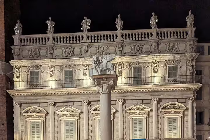 Illuminated Palazzo Maffei and column in Piazza delle Erbe, key landmark on Verona live guide walking tour