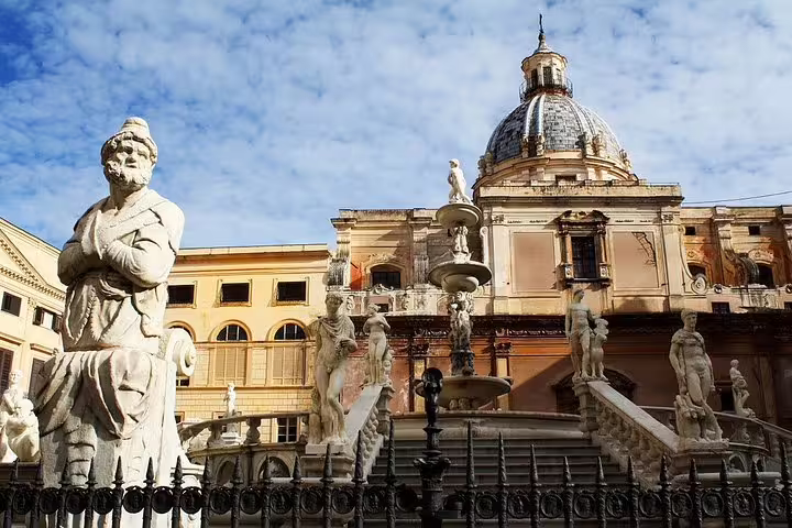 Piazza Pretoria fountain with baroque statues and dome of Santa Caterina church in central Palermo, Sicily, on a cruise passenger tour