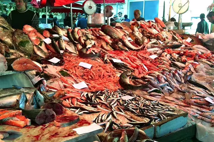 Colorful seafood stall at Palermo street market, showcasing fresh fish and prawns on a private shore excursion tour