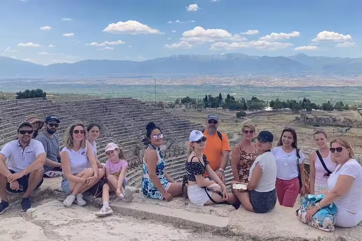 Small group at ancient theater in Pamukkale with scenic mountain and valley views on a sunny day.
