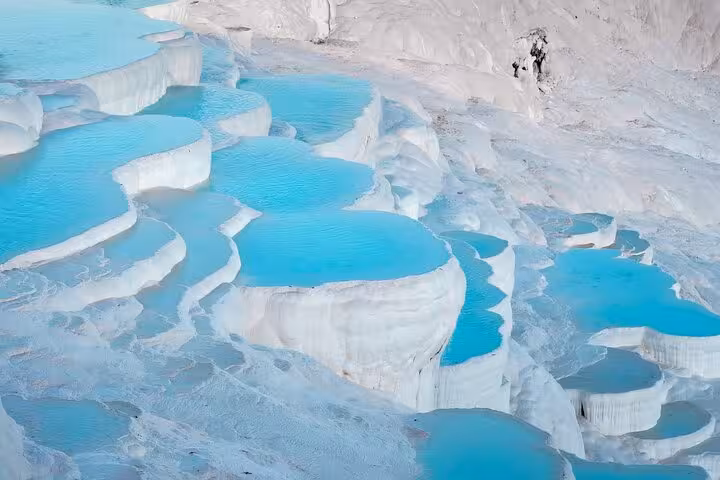 Pamukkale white travertine terraces with turquoise thermal pools on a 5-day guided Istanbul Ephesus tour
