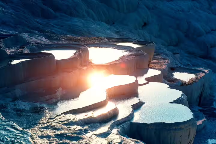 Witness the breathtaking sunset over Pamukkale's travertine terraces on a small group tour from Izmir.