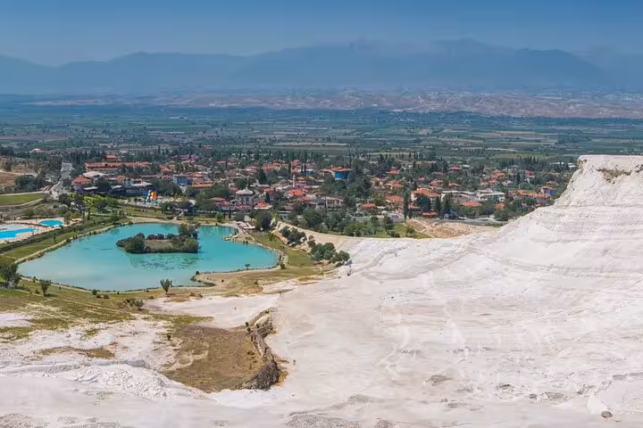 Panoramic view of Pamukkale white travertine slopes and turquoise lake on an all-inclusive private guided tour