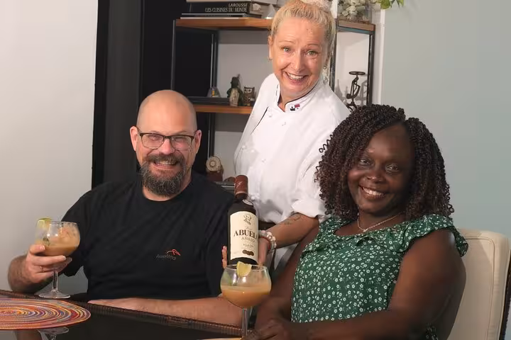 Guests enjoying cocktails with the chef after a boozy Panamanian cooking class, showcasing local rum.