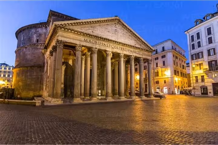 Evening view of the illuminated Pantheon entrance in Rome, perfect for skip-the-line tours with an audio guide.