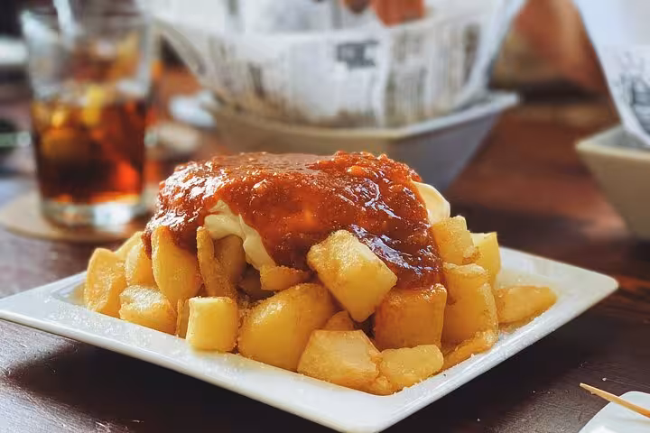 Patatas bravas with spicy sauce, classic tapas on Ruzafa evening food and wine tour in Valencia