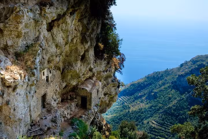 Dramatic cliffside view along Path of the Gods, showcasing Amalfi Coast's breathtaking landscapes and sea vistas.