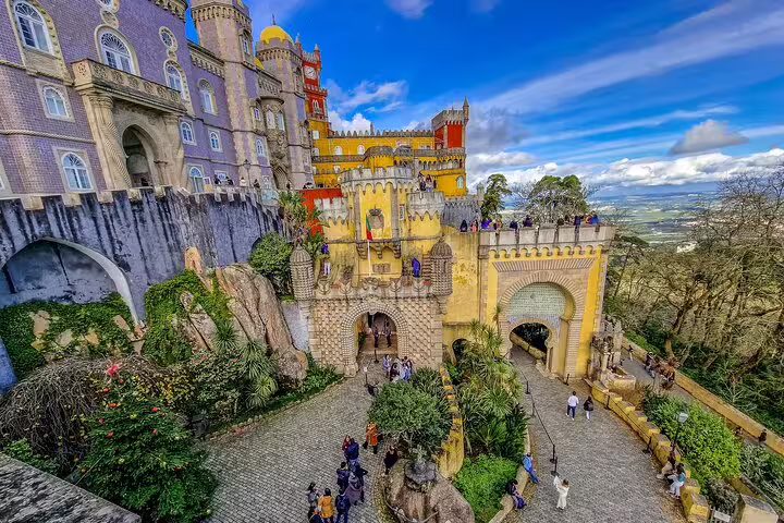 Colorful Pena Palace in Sintra, Portugal, showcasing vibrant architecture and scenic views, featured in a private tour from Lisbon.